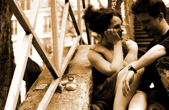 picutre of a couple sitting on stairway talking