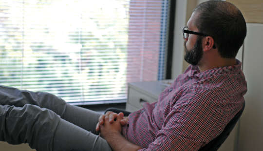 man sitting in a chair looking outward