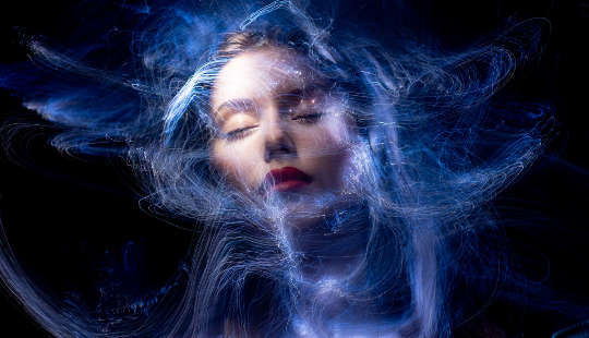 woman's face surrounded by a hazy web