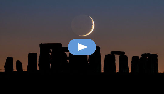 Crescent moon setting over Stonehenge