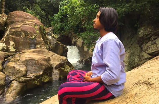 a young man meditation outside