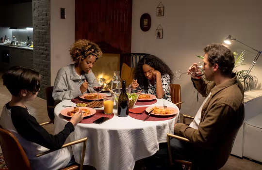 family sitting around a table eating