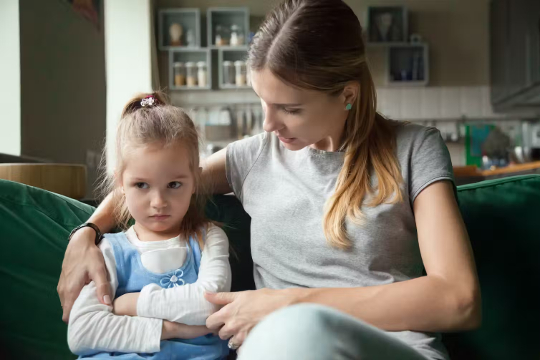 a mother sitting with her young child