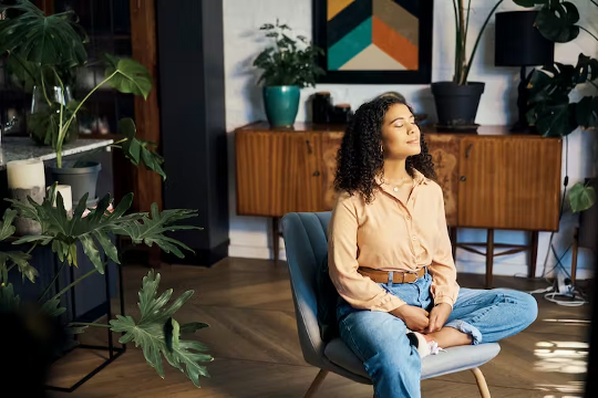 a woman sitting in a chair meditating