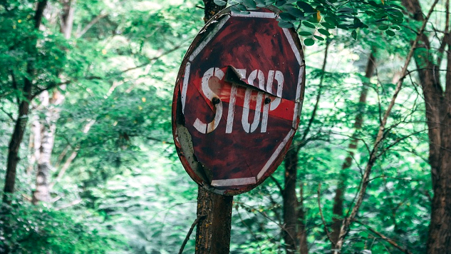 a worn and damaged stop sign