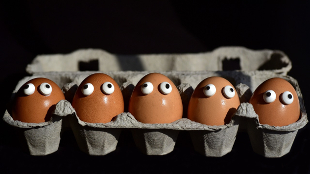 a box of eggs with googly eyes