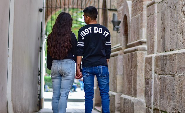 man and woman walking down the street