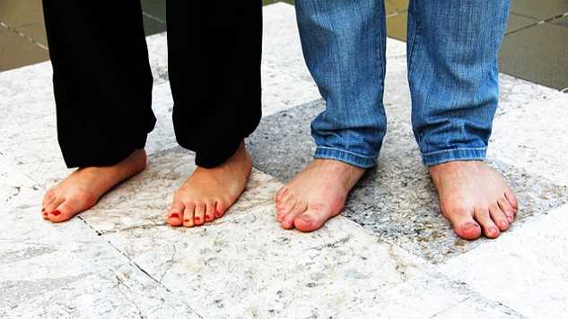 two pairs of bare feet standing firm