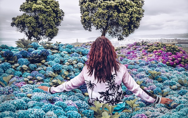 a woman standing in a field of flowers