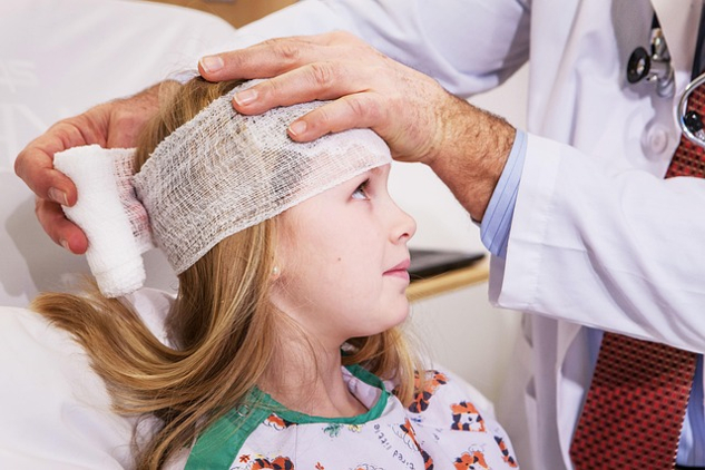 a woman with a head bandage in a hospital setting