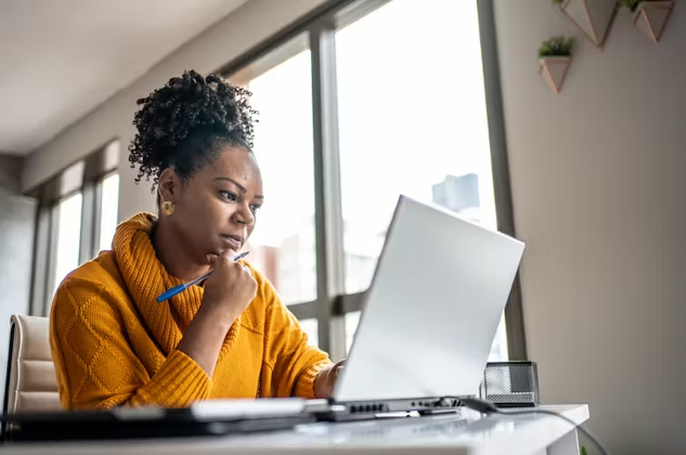 woman sitting working on a laptop