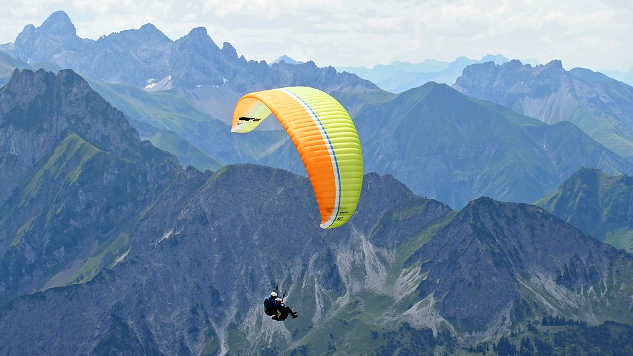 paraglider in the sky near a mountainous range