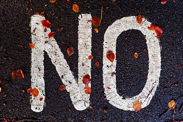 the word "NO" written on the pavement