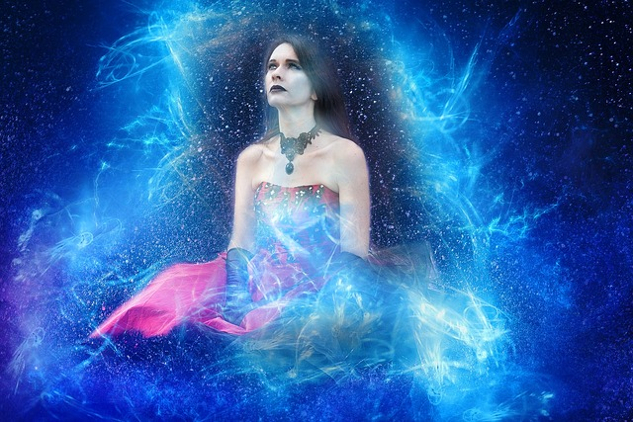 sitting woman surrounded by energy and the starry heavens