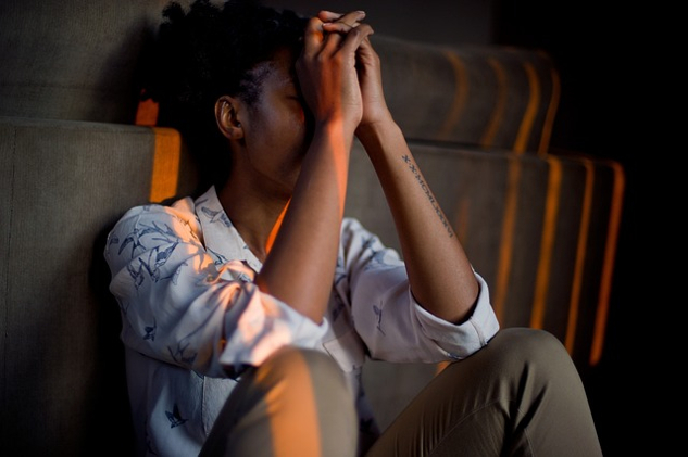 a person sitting on the floor against the wall