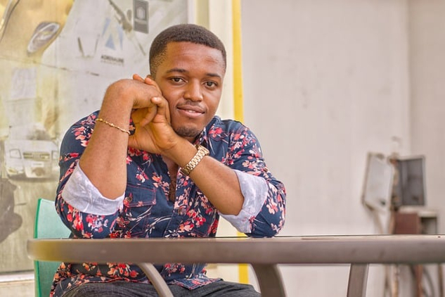 photo of a confident black man sitting at a table