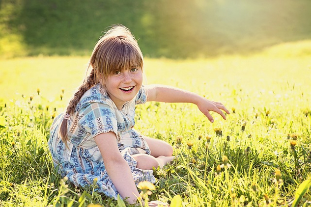 radiant young girl in an equally radiant meadow