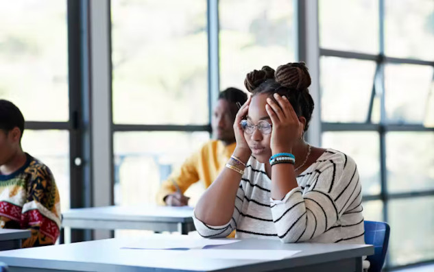 A stressed college student representing the challenge of time poverty in higher education.