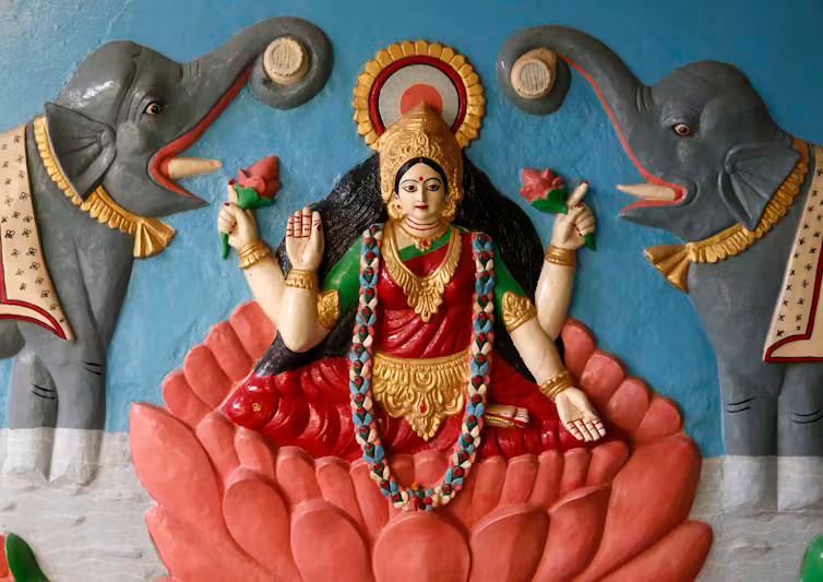 Relief of the Hindu goddess Lakshmi standing on a lotus, symbolizing purity, wisdom, and auspiciousness in Indian religious traditions.