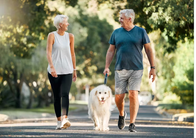 Person walking with an upright posture in a park, showing improved spinal health.