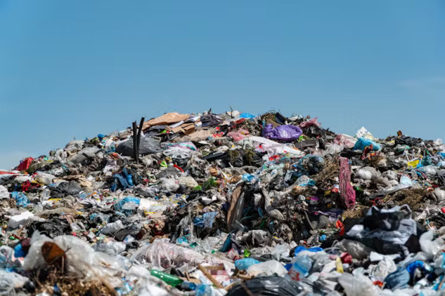 Suggested Alt Image Text:  A degraded landfill leaking into nearby soil and water, illustrating the ongoing threat of PCB pollution to the environment.