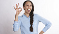 woman with a big smile and fingers in an "a-ok" symbol