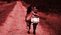 two children walking down a road with the taller one with her arm around the shoulders of the younger one