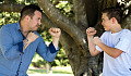 a father and son facing each other wearing boxing gloves