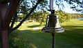 a bell or gong hanging from a tree