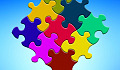 brightly multi-colored puzzle pieces joined together